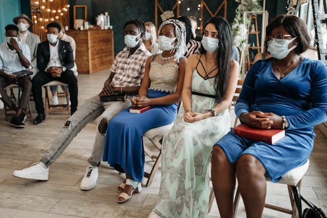 Community members participating in a facilitated consultation session as part of a public health programme, illustrating participatory approaches and dialogue with affected populations.